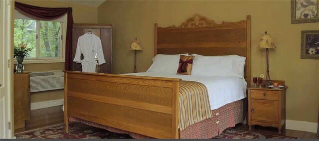 bedroom featuring dark hardwood / wood-style flooring