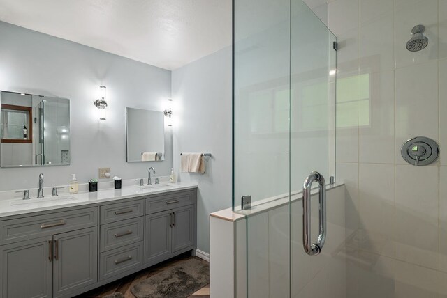 bathroom with walk in shower and double sink vanity