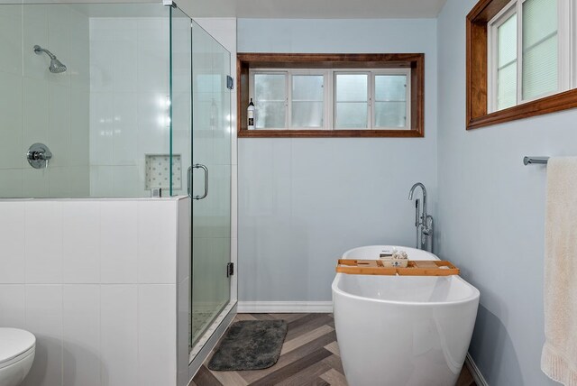 bathroom with walk in shower, toilet, and parquet floors