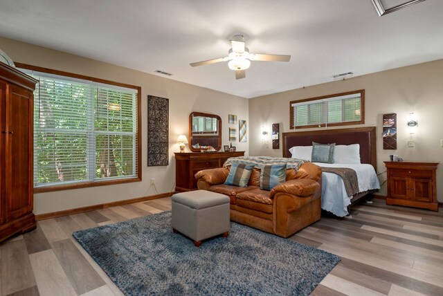 bedroom with ceiling fan and light hardwood / wood-style flooring