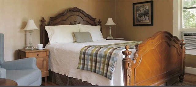 bedroom with dark hardwood / wood-style flooring