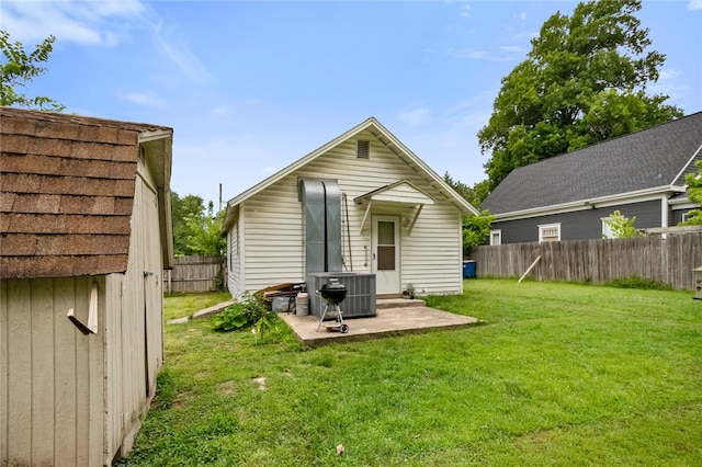 rear view of house featuring a patio and a yard