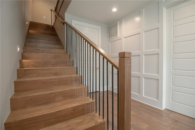 stairway featuring light hardwood / wood-style floors