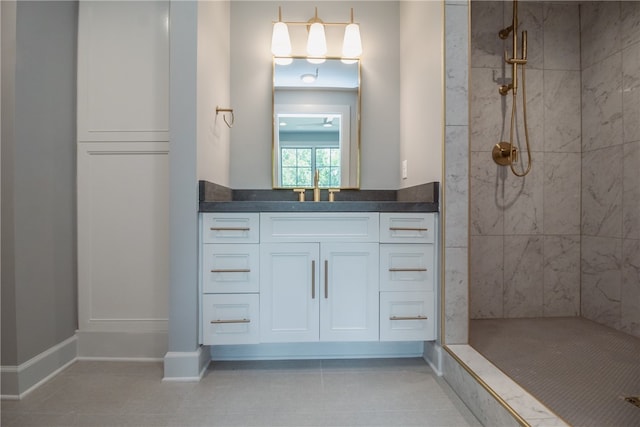 bathroom featuring a tile shower, tile floors, and vanity