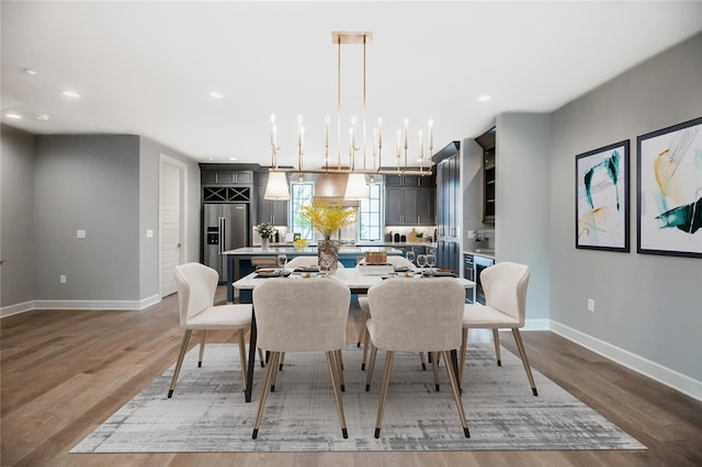 dining area featuring an inviting chandelier and hardwood / wood-style floors