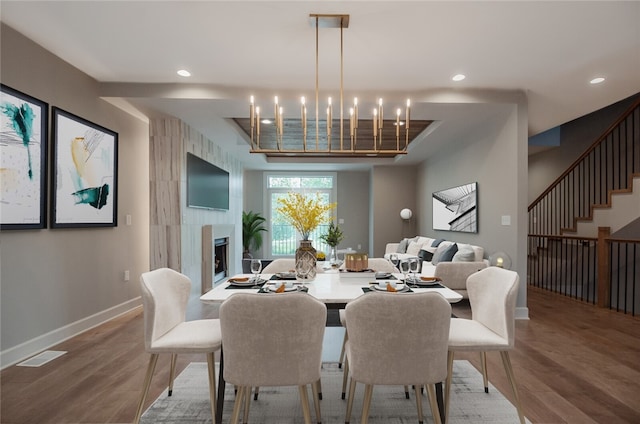 dining space with dark hardwood / wood-style floors and a chandelier