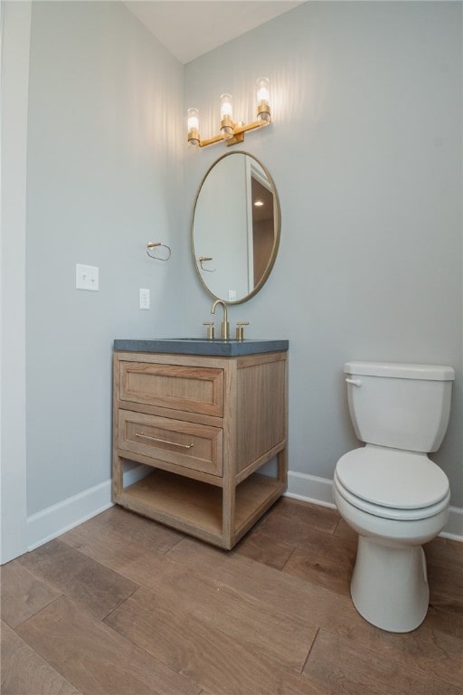 bathroom featuring toilet and vanity