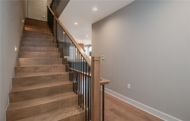 stairway with dark wood-type flooring