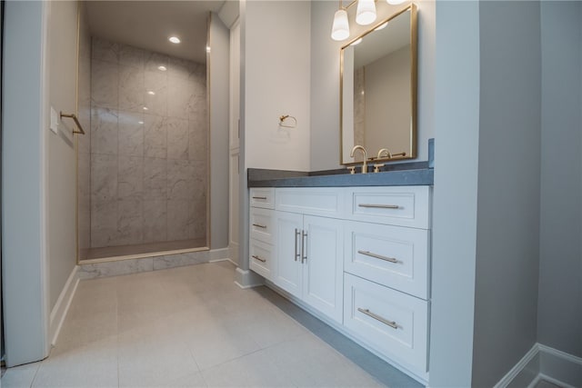 bathroom featuring tile floors, vanity, and tiled shower