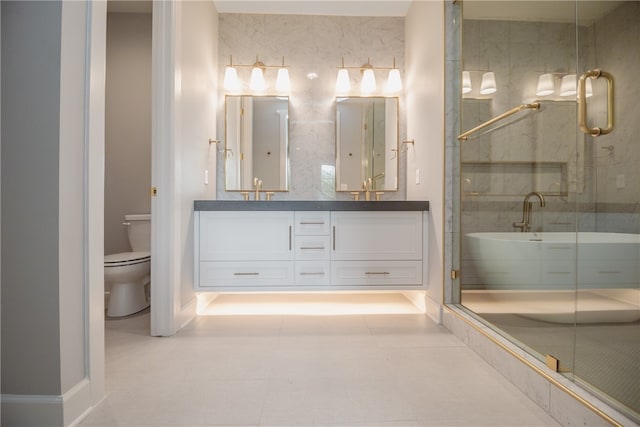 bathroom featuring tile walls, double sink vanity, tile floors, a shower with door, and toilet