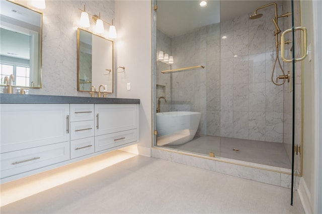 bathroom featuring a shower with door, vanity with extensive cabinet space, tile floors, and double sink