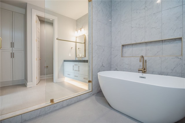 bathroom featuring oversized vanity, tile walls, and tile floors