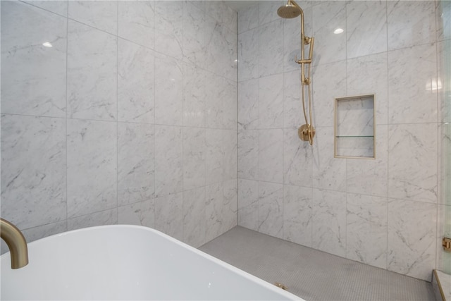 bathroom featuring shower with separate bathtub