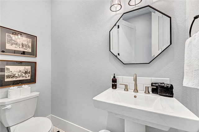 bathroom with toilet and sink