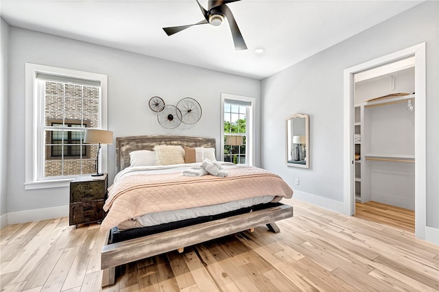 bedroom with ceiling fan and light wood-type flooring