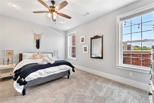 bedroom with light carpet and ceiling fan