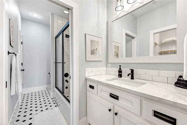 bathroom featuring tile floors, vanity, and a shower with shower door