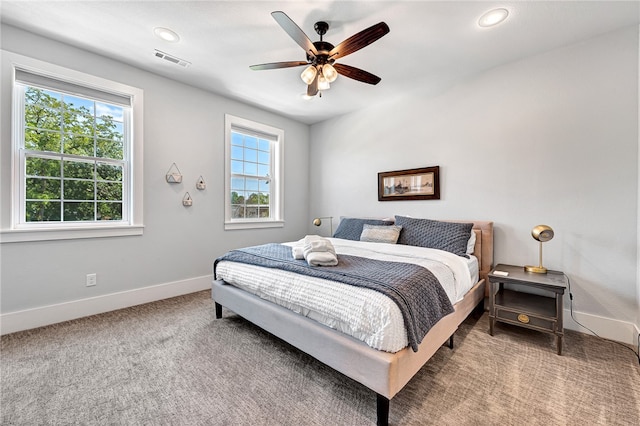 bedroom with light carpet and ceiling fan