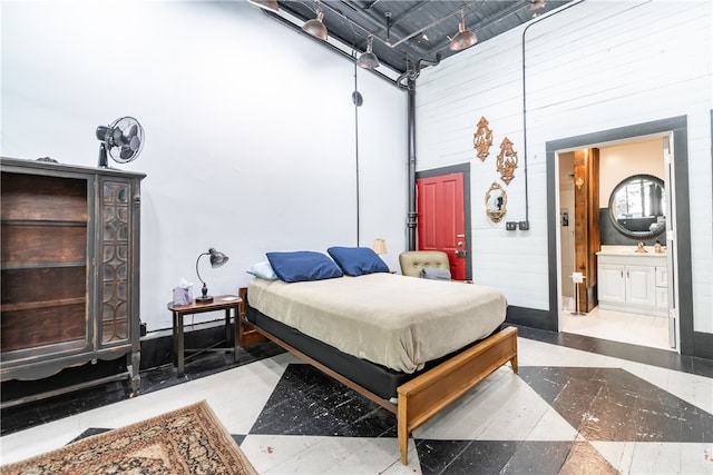 tiled bedroom featuring connected bathroom and a towering ceiling