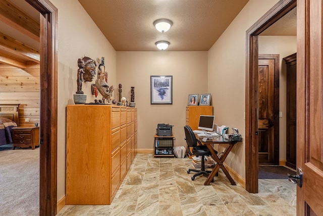 office area with wooden walls and light colored carpet