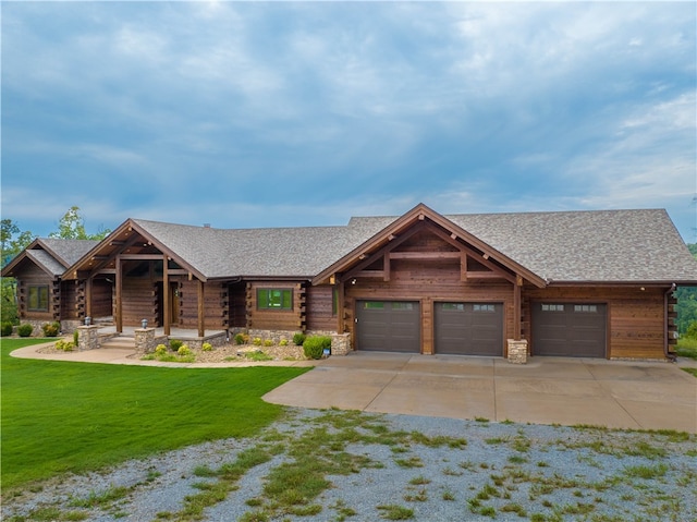 log cabin featuring a front lawn and a garage