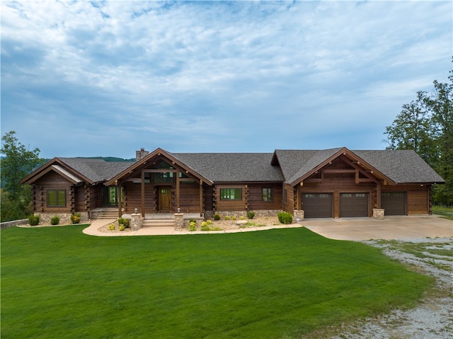 log cabin with a front yard and a garage