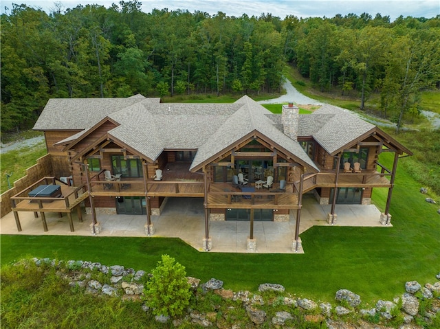 rear view of property with a patio, a yard, and an outdoor living space