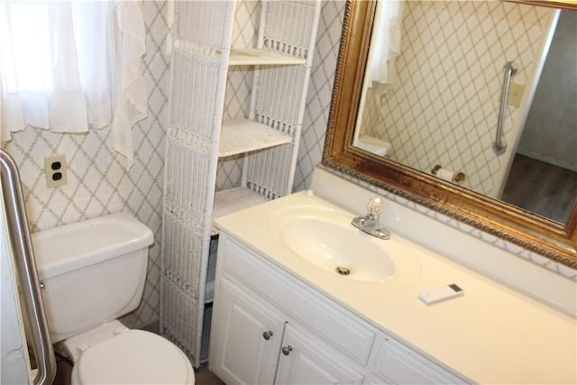 bathroom featuring vanity and toilet