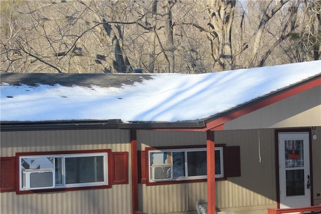 snow covered property featuring cooling unit