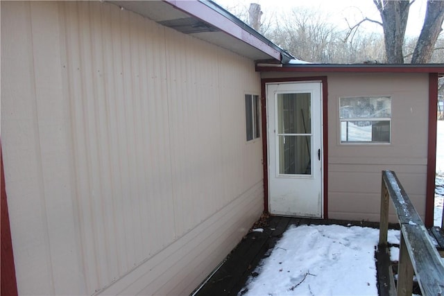 view of snow covered property entrance