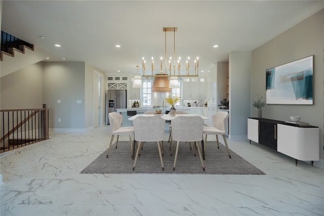 tiled dining space with a chandelier