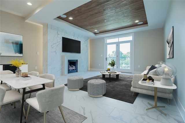 tiled living room with french doors, wood ceiling, a tray ceiling, and a high end fireplace