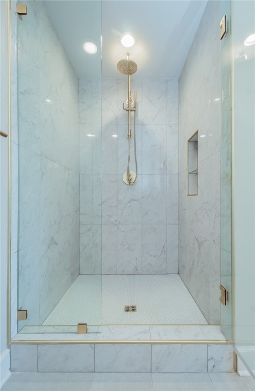 bathroom featuring a tile shower and tile floors