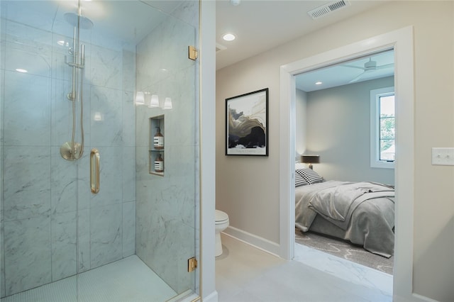 bathroom with tile flooring, toilet, and a shower with shower door