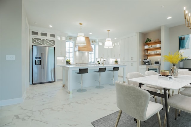 tiled dining room featuring sink