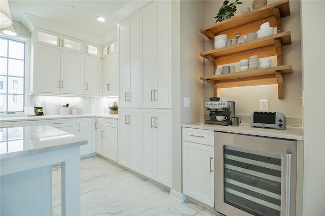 kitchen with light tile floors, beverage cooler, tasteful backsplash, white cabinetry, and a healthy amount of sunlight