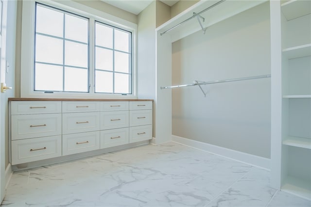 spacious closet featuring light tile floors