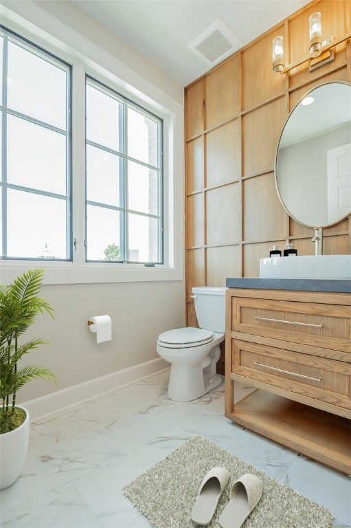 bathroom featuring vanity, tile flooring, and toilet