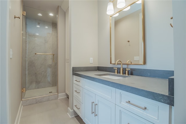 bathroom featuring tile floors, a shower with shower door, and vanity