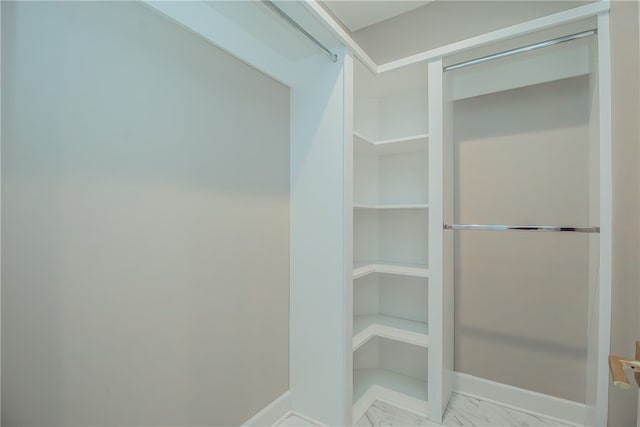 spacious closet featuring light tile floors