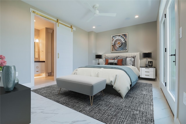 bedroom featuring a barn door, ensuite bath, ceiling fan, and light tile floors