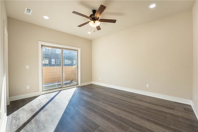 spare room with dark wood-type flooring and ceiling fan