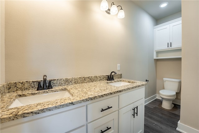 bathroom with vanity, toilet, and hardwood / wood-style flooring