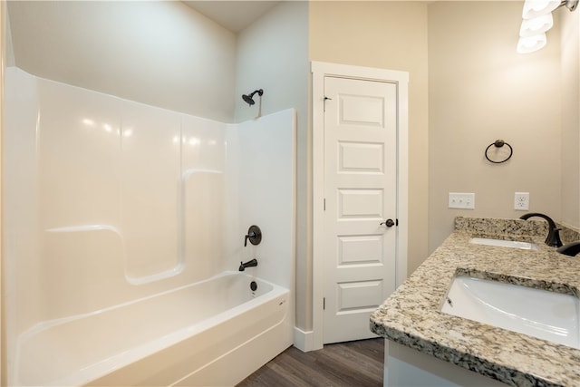 bathroom featuring vanity, wood-type flooring, and shower / bath combination