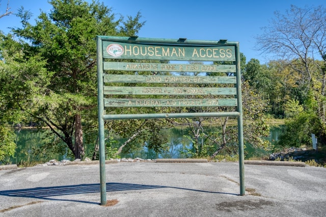 community / neighborhood sign with a water view