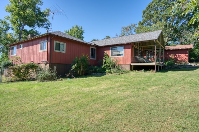 back of property featuring a yard