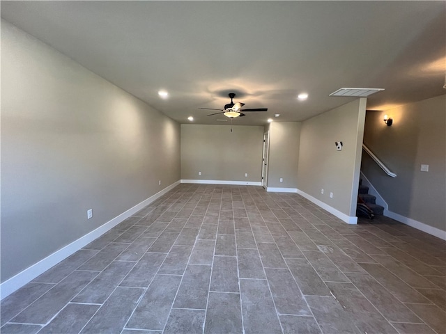 tiled spare room featuring ceiling fan