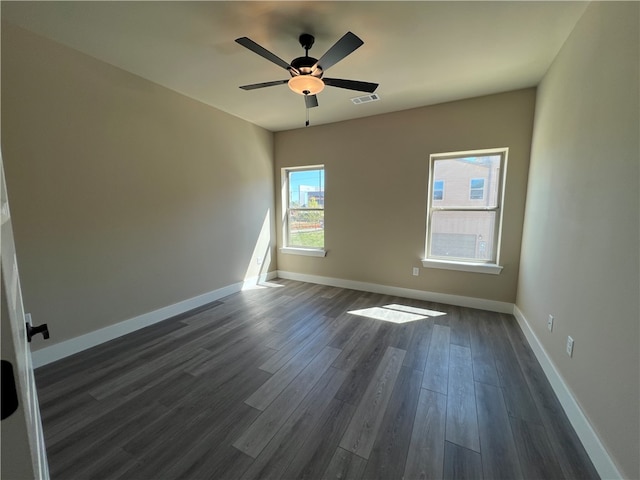 spare room with ceiling fan and dark hardwood / wood-style floors