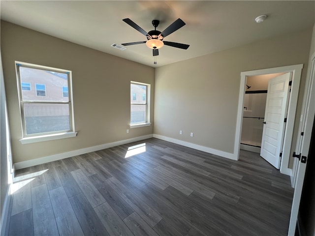 empty room featuring dark hardwood / wood-style flooring and ceiling fan