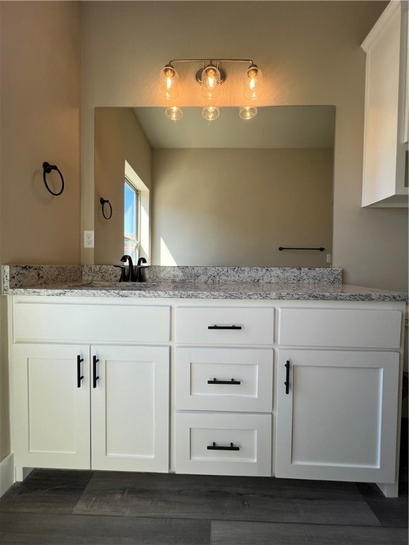 bathroom with vanity and hardwood / wood-style floors